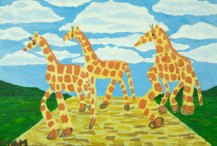 Three giraffes walking on a path with a blue sky and green landscape in the background.