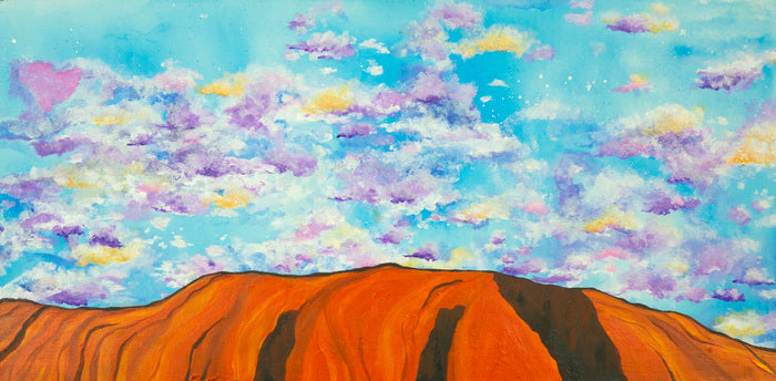 Painting of a desert landscape with a large rock formation under a colorful sky.